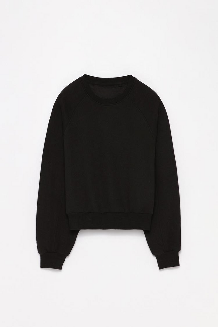 Zoomed-out view of a women's black basic cropped sweatshirt, highlighting the full design, including the cropped length and relaxed fit.