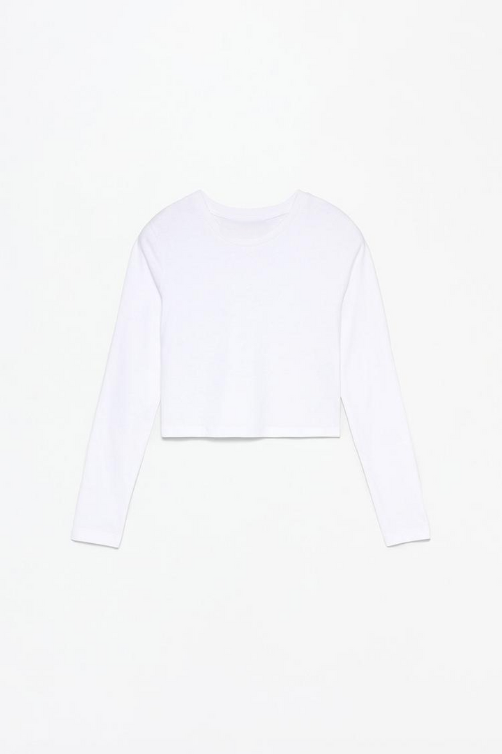 Full view of the white cropped long-sleeve top, showcasing its sleek design with long sleeves and a cropped fit. Perfect for a chic, casual look or as part of a stylish layered outfit.