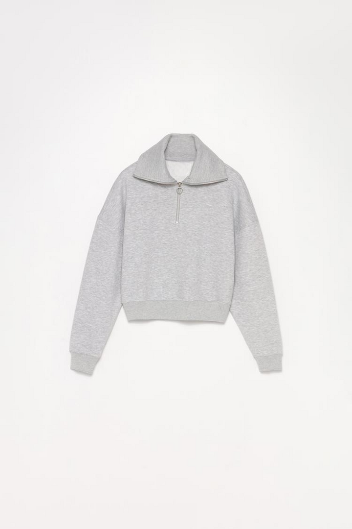 Zoomed-out view of a women's grey sweatshirt with a zip-up collar, showcasing the full design, including the relaxed fit and collar details.