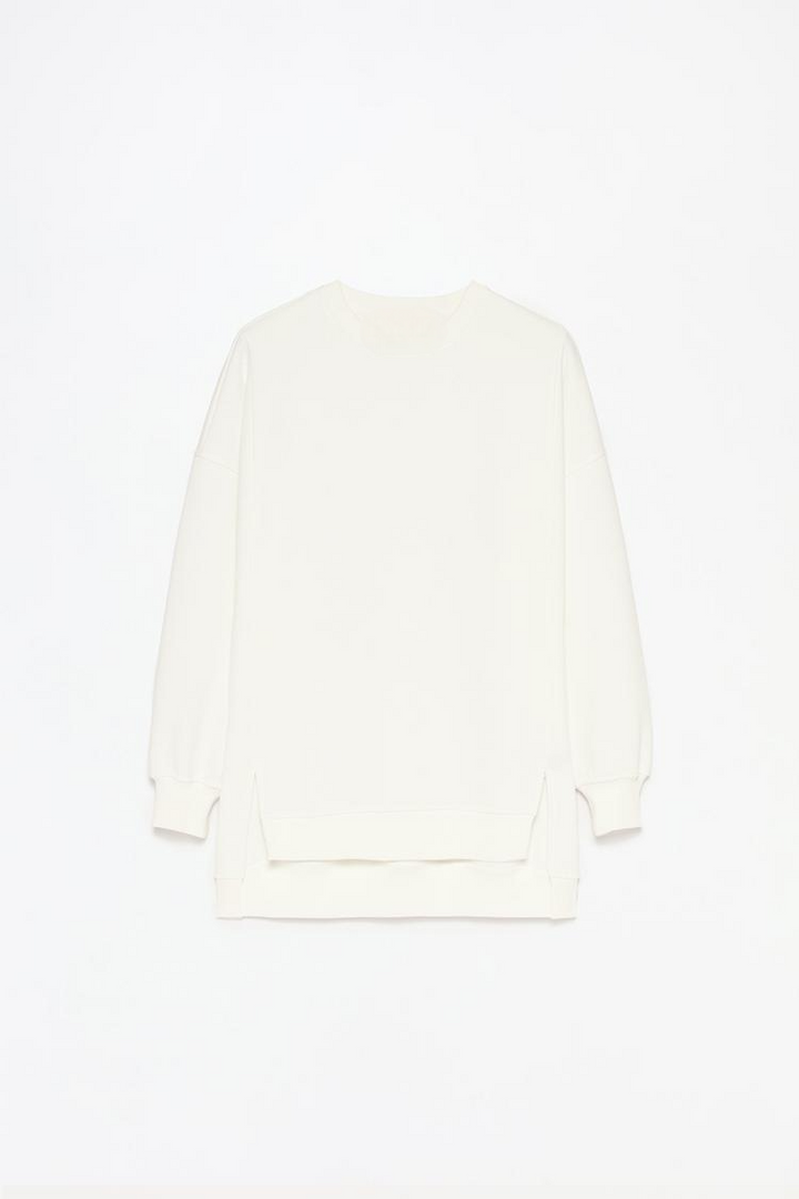 Women's white oversized sweatshirt with an asymmetric design, offering a stylish and comfortable fit for casual wear.
