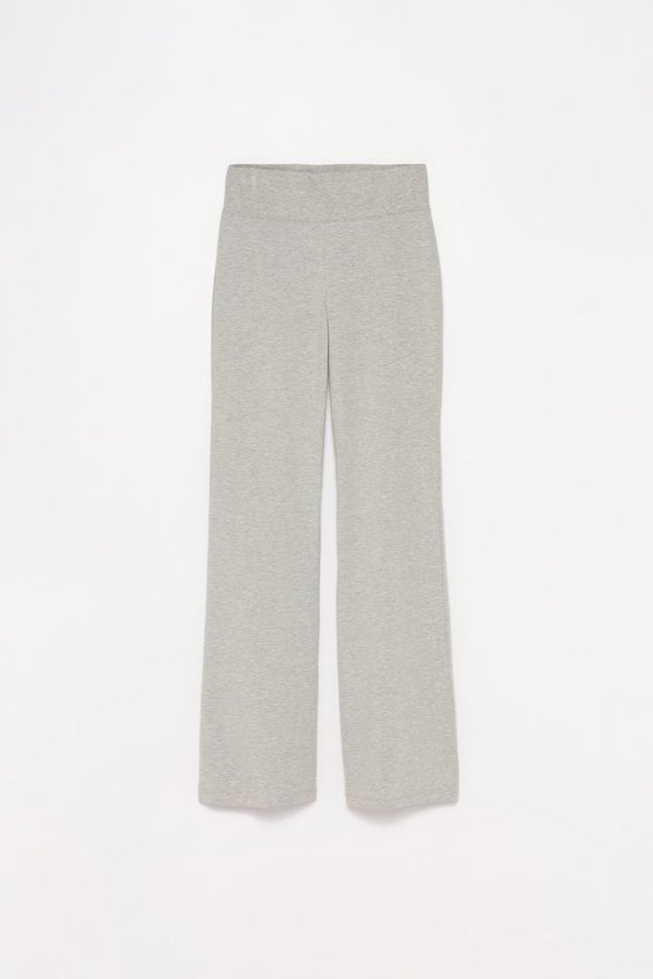 Complete product shot of the grey flared leggings, highlighting the ribbed waistband and the relaxed fit that flares from the knee.