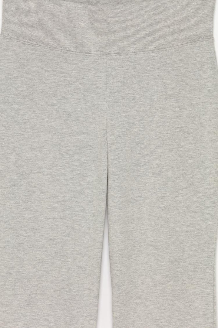 Product image focusing on the grey flared leggings and the ribbed waistband detail that enhances their design.