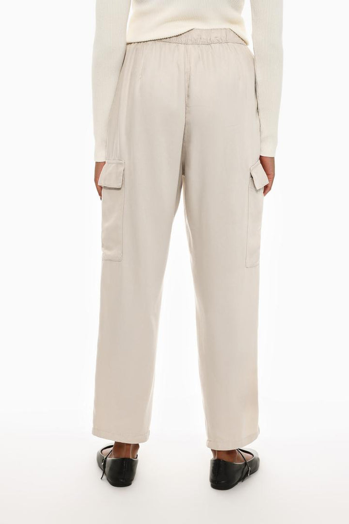 Rear view of the beige flowing cargo joggers, showcasing their streamlined fit and minimalistic aesthetic.