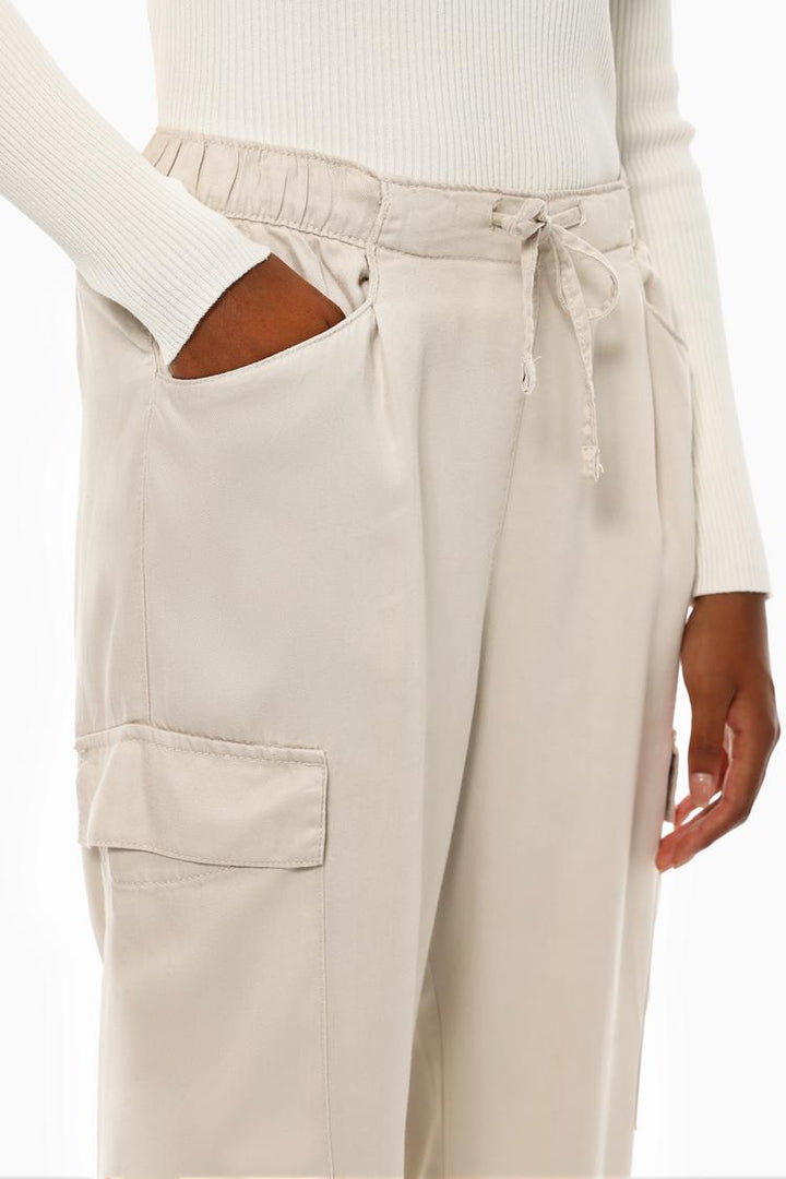 Front view of the beige flowing cargo joggers, featuring a clean design with practical cargo pockets.