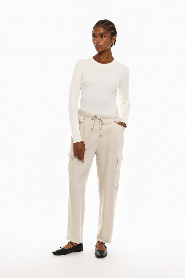 Full-body view of the beige flowing cargo joggers, paired with complementary pieces for inspiration.