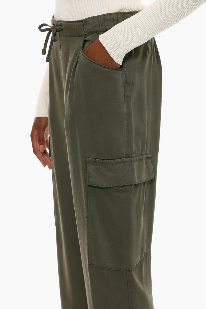 Side view of the green flowing cargo joggers, highlighting the utility pockets and flowing silhouette.
