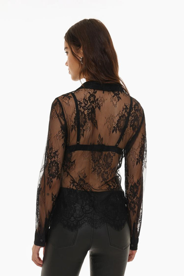 Rear view of a lace shirt highlighting its elegant design, intricate floral patterns, and seamless finish for a graceful appearance.