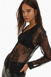 Side view of a lace shirt showcasing its delicate texture, slim fit, and intricate detailing along the edges, adding a touch of sophistication.