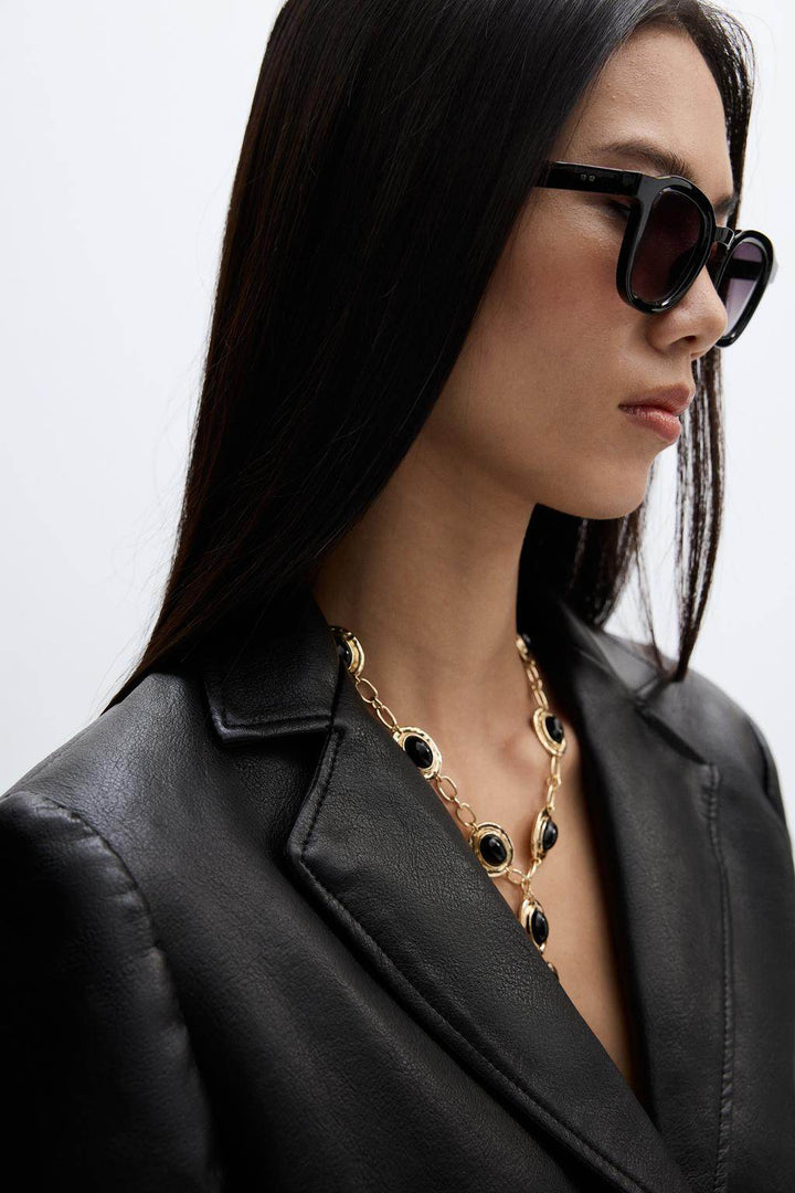 Close-up front view of the leather blazer's lapel and zipper

