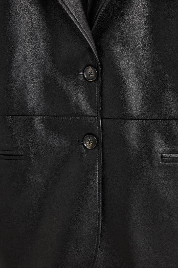 Close-up product image of the leather blazer's zipper and hardware

