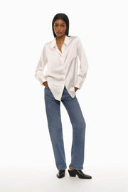 A white long-sleeve satin shirt that exudes elegance and sophistication. Crafted from silky, smooth fabric, it features a classic collar, button-down front, and a relaxed fit, perfect for formal occasions or elevating everyday wear.