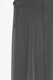 Product close-up of grey loose-fitting wide-leg trousers, showcasing their premium design and versatility