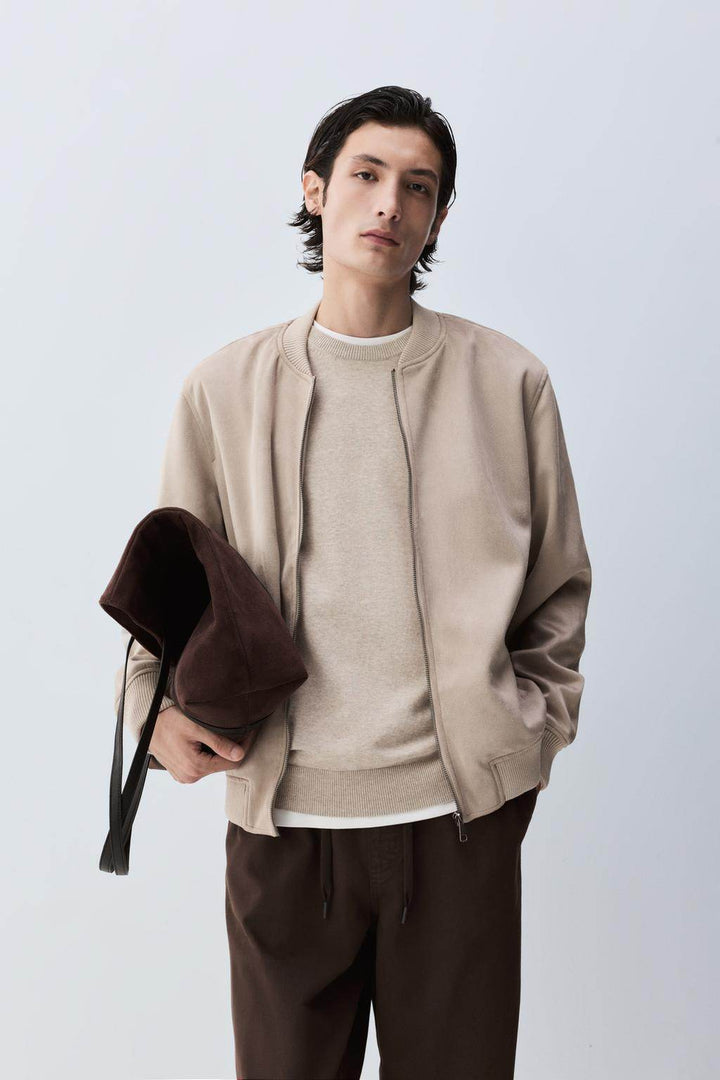 Front view of men's beige faux suede bomber jacket

