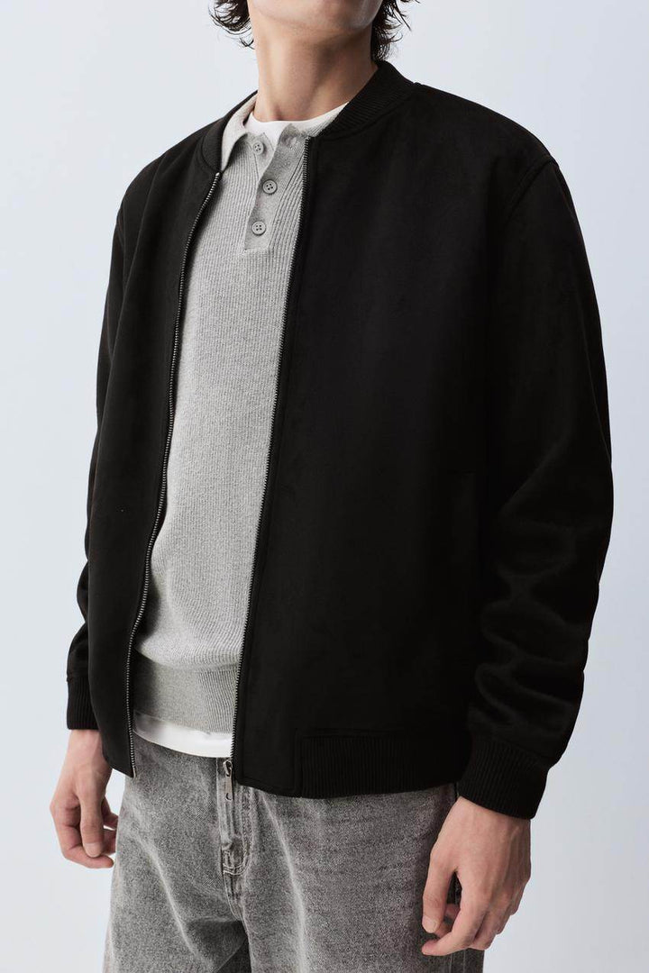 Close-up front view of black faux suede bomber

