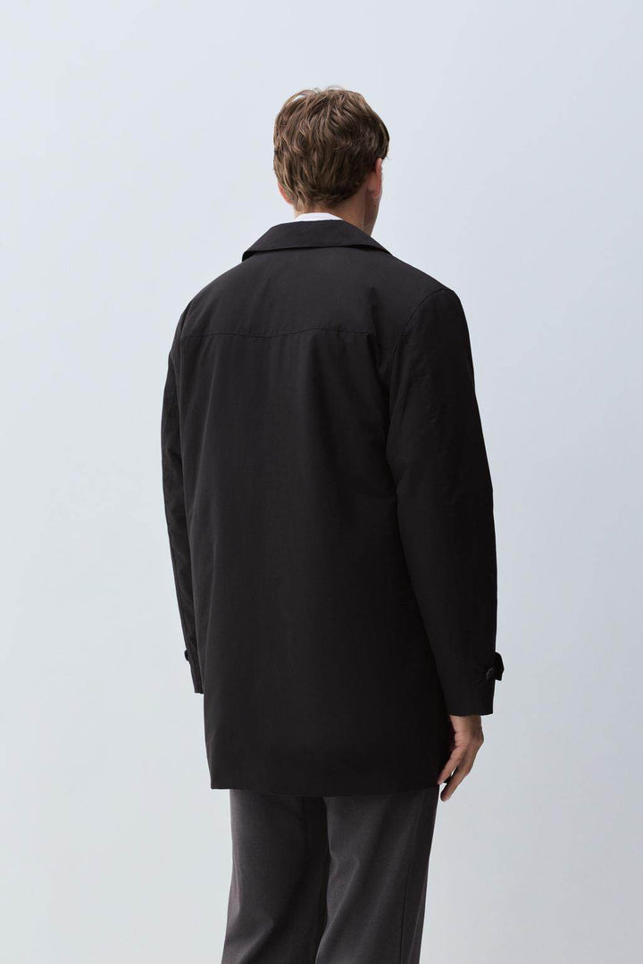 Back view of the men's black padded trench coat

