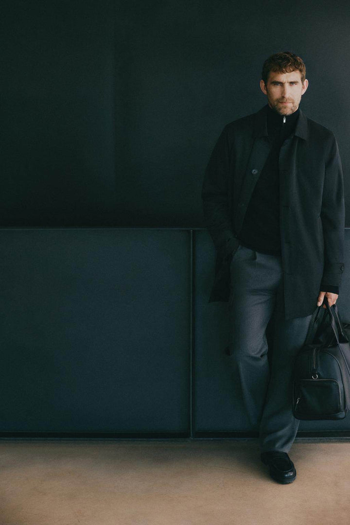 Model showcasing black padded trench coat front

