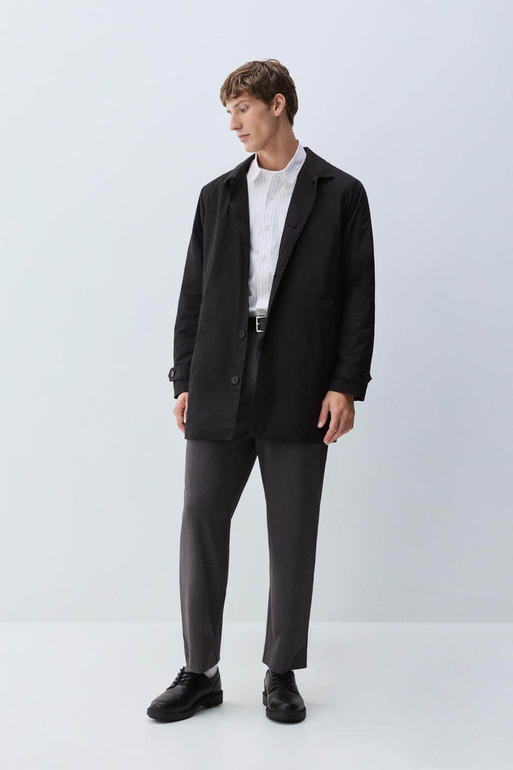 Full side view of the black padded trench coat

