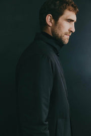 Side view of men's black padded trench coat

