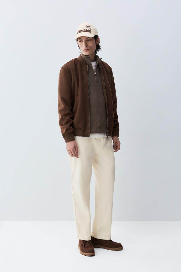 Full body front view of man wearing brown faux suede bomber

