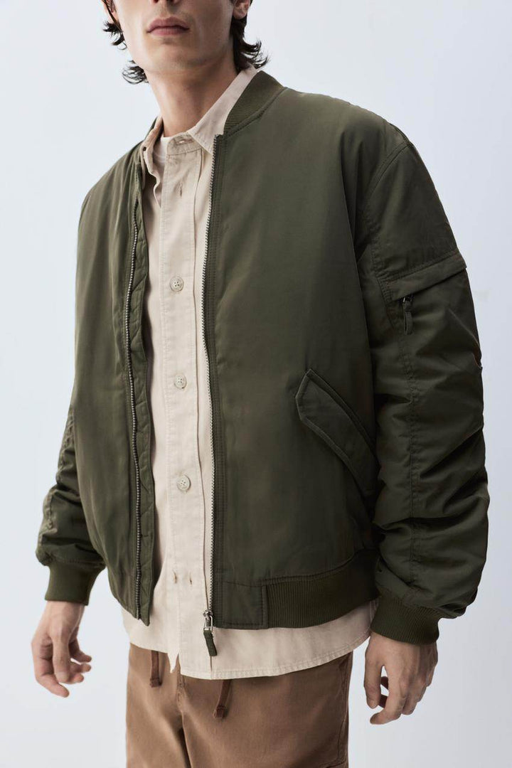 Close-up front view of green padded bomber jacket

