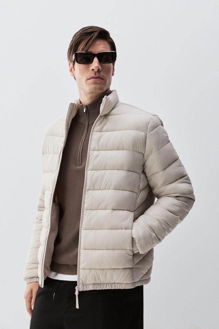 Model showcasing grey lightweight puffer jacket front

