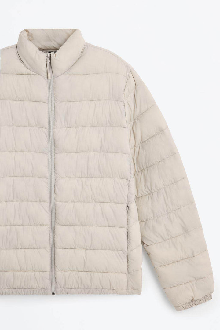 Close-up product image of grey puffer jacket

