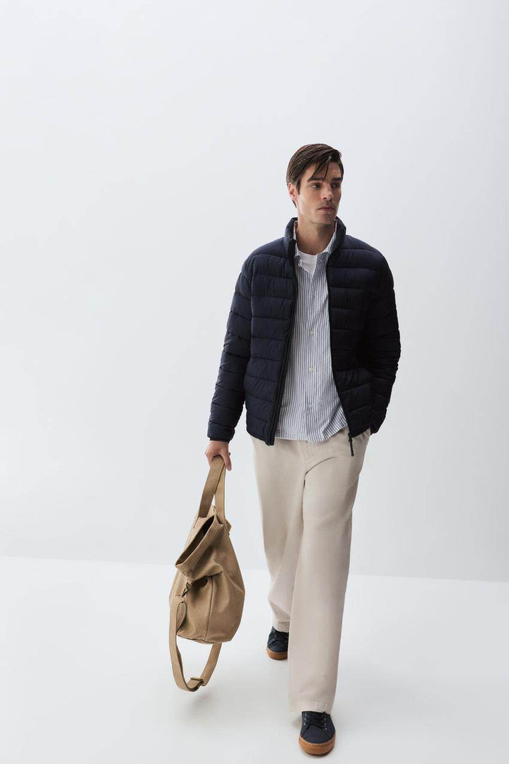 Model showcasing navy lightweight puffer jacket front

