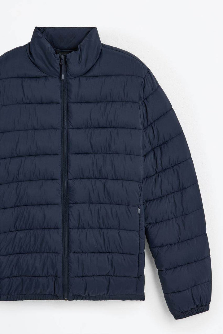 Close-up product image of navy puffer jacket

