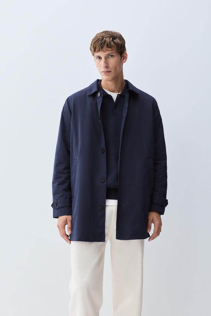 Front view of men's navy padded trench coat

