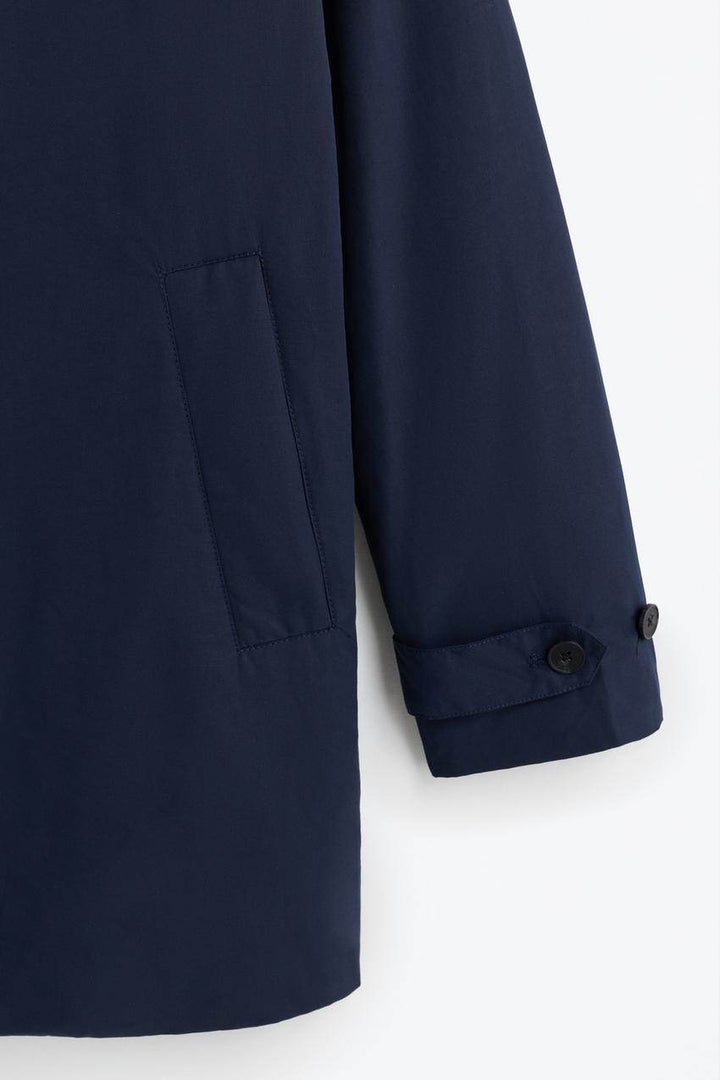 Close-up of navy padded trench coat fabric

