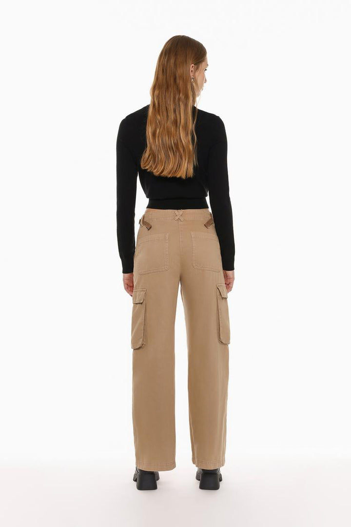 Rear view of the beige cargo trousers, showcasing the unique buckle details and tailored back pockets.