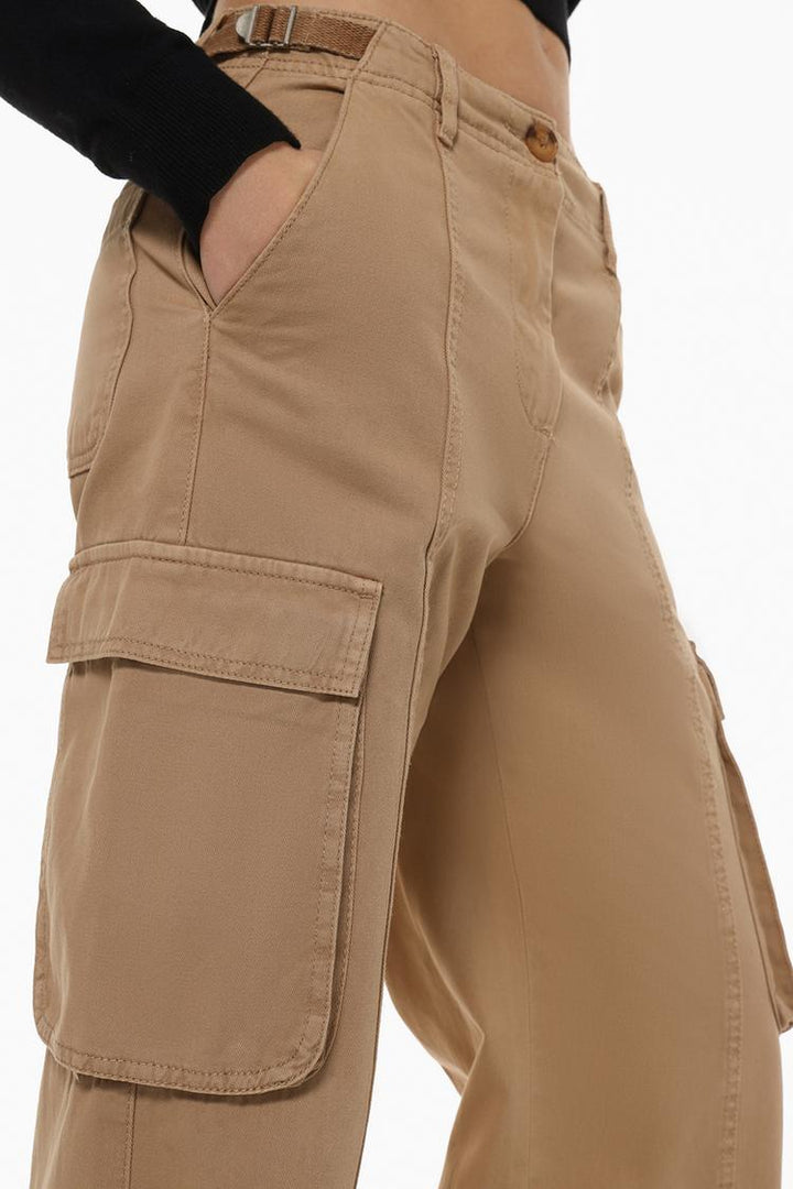 Side profile of the beige cargo trousers, highlighting the spacious cargo pockets and adjustable buckles.
