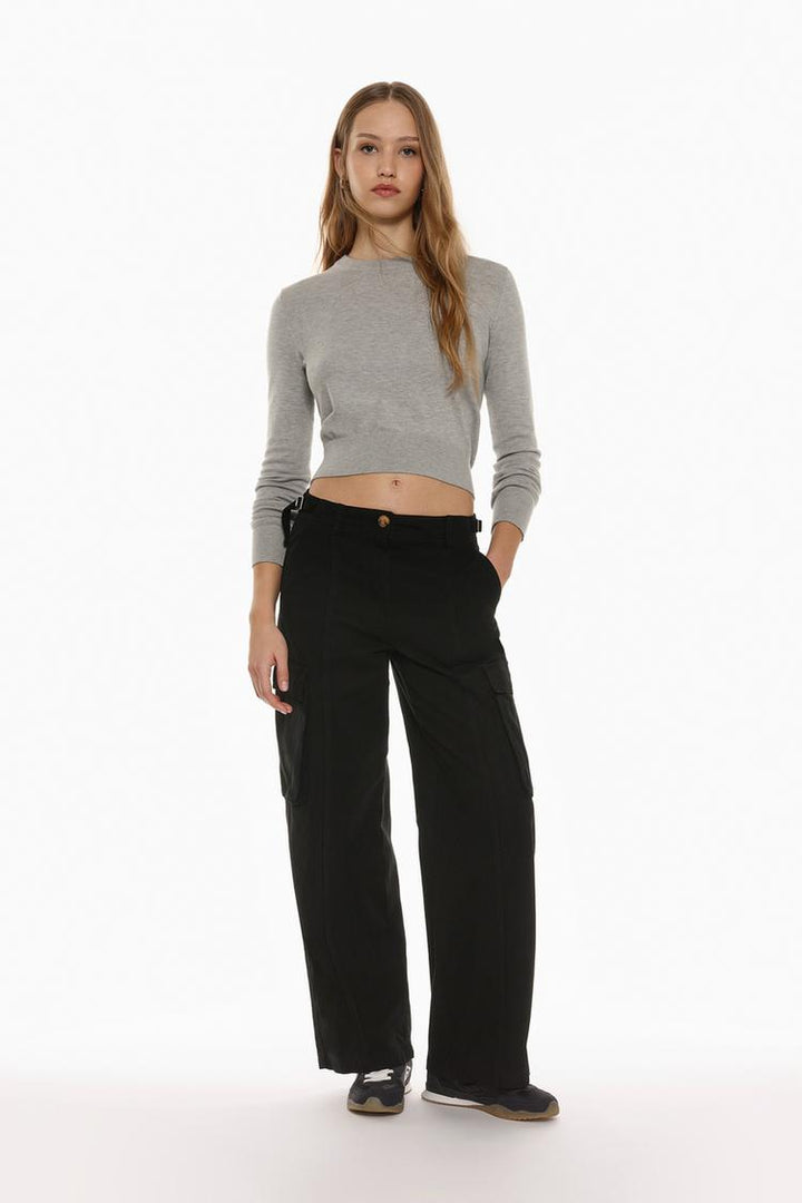 Modern black oversize cargo trousers with statement buckles, perfect for casual and edgy outfits.