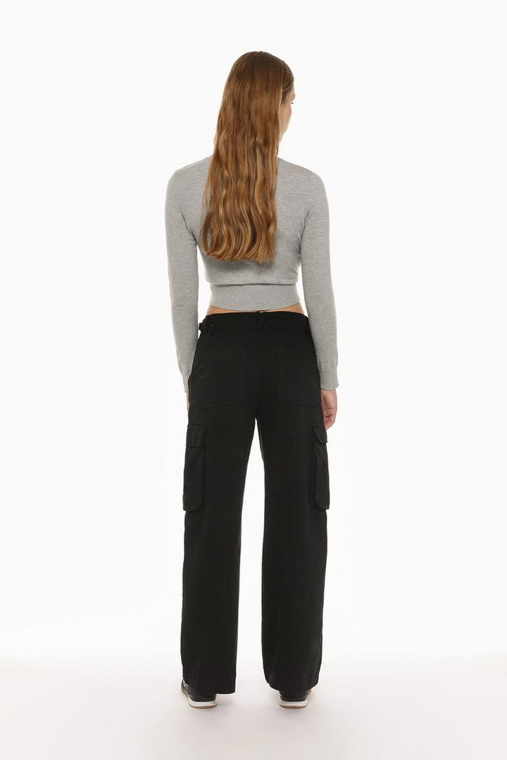 Rear view of the black cargo trousers, showcasing their utility style and sleek tailoring.