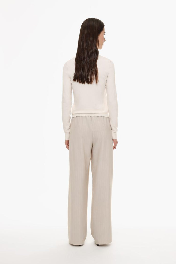Back view of beige straight-fit trousers, featuring well-structured seams and comfort