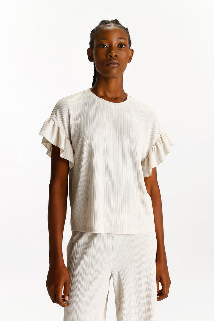 Front view of the beige textured culottes, highlighting their simple yet chic design.