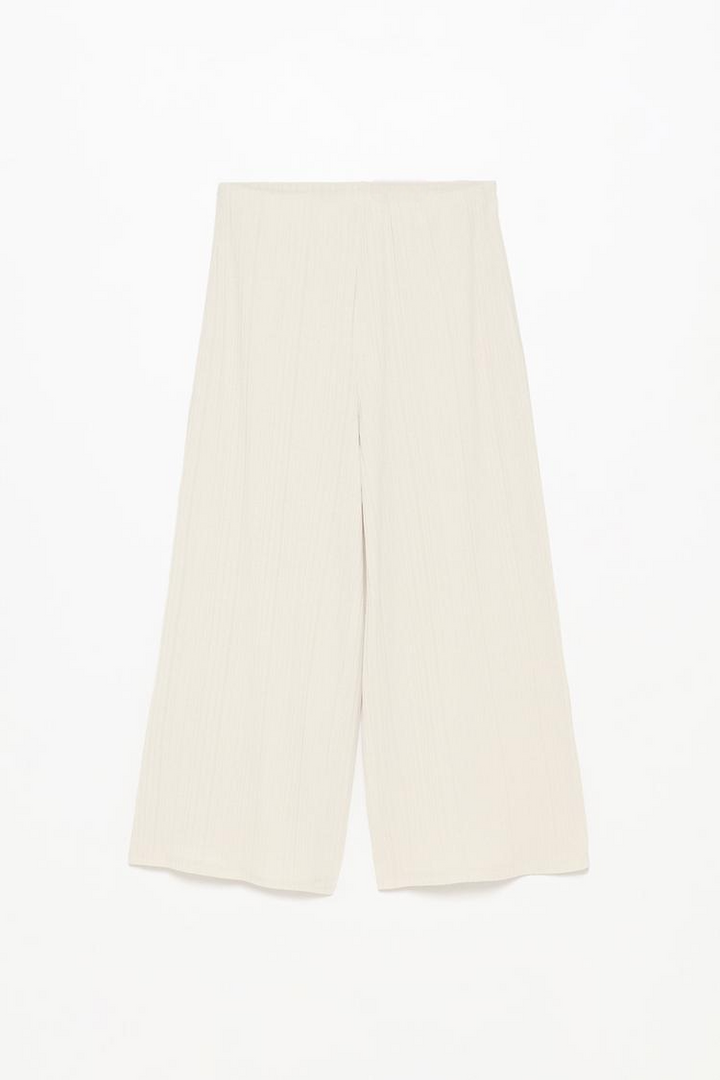 Close-up product shot of the black textured culottes, focusing on texture and quality craftsmanship.