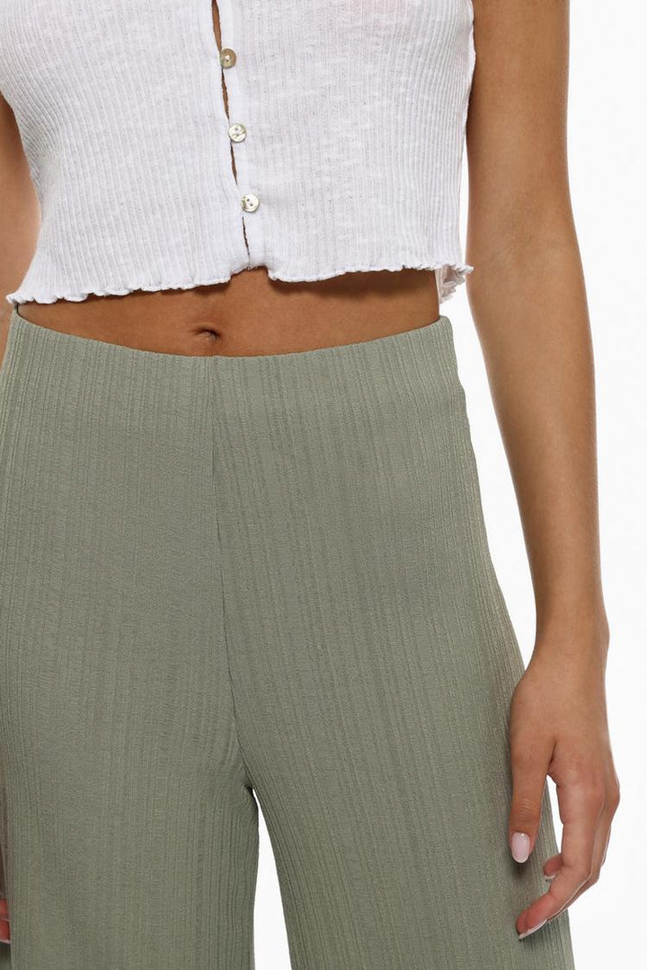 A styled ensemble featuring the green textured culottes, demonstrating their versatility for any occasion.