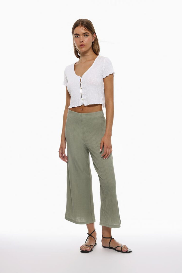 Full-body look of the green textured culottes, styled with complementary pieces for inspiration.