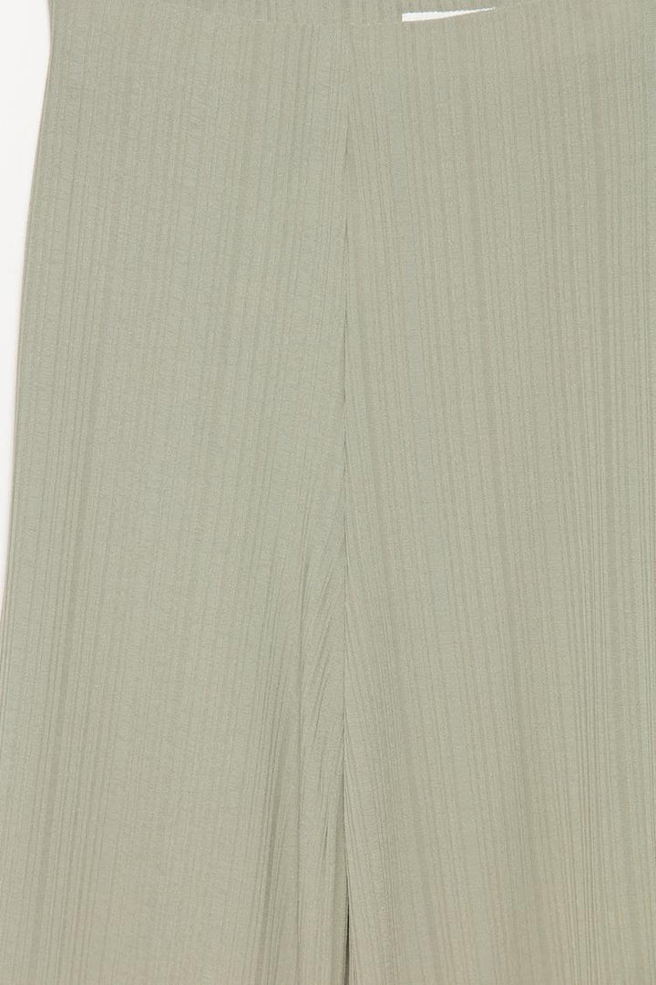 Close-up of the green textured culottes, emphasizing the texture and premium craftsmanship.
