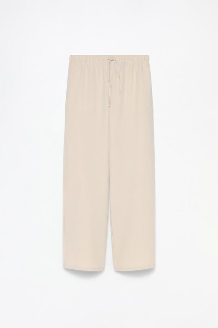 Full product shot of beige wide-leg smart trousers, highlighting their sophisticated style