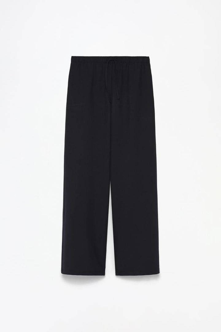 Full product shot of black wide-leg smart trousers, showcasing their sleek and modern design