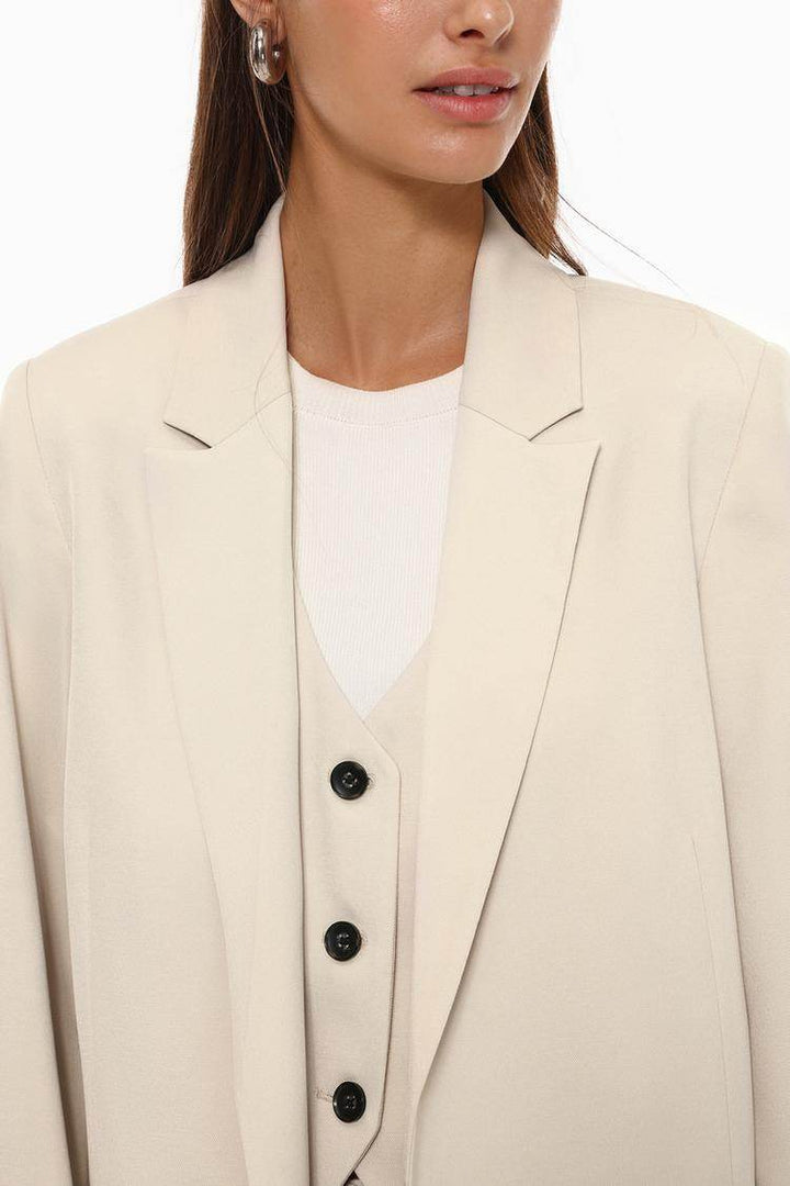 Close-up front view of beige basic blazer


