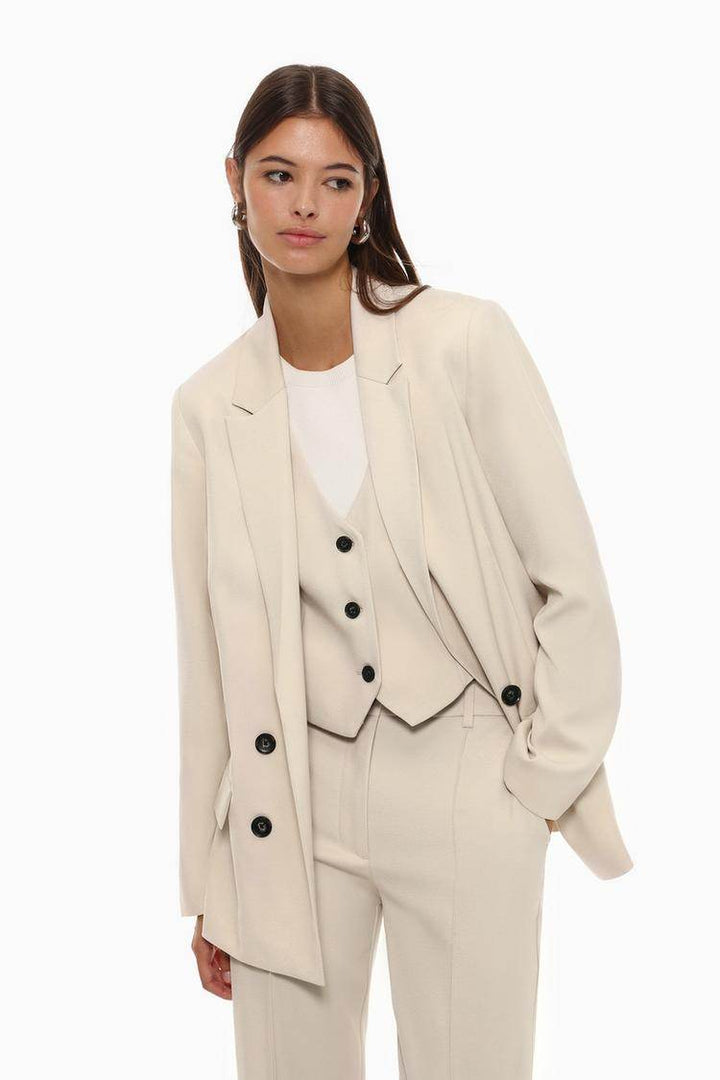 Front view of women's beige basic blazer

