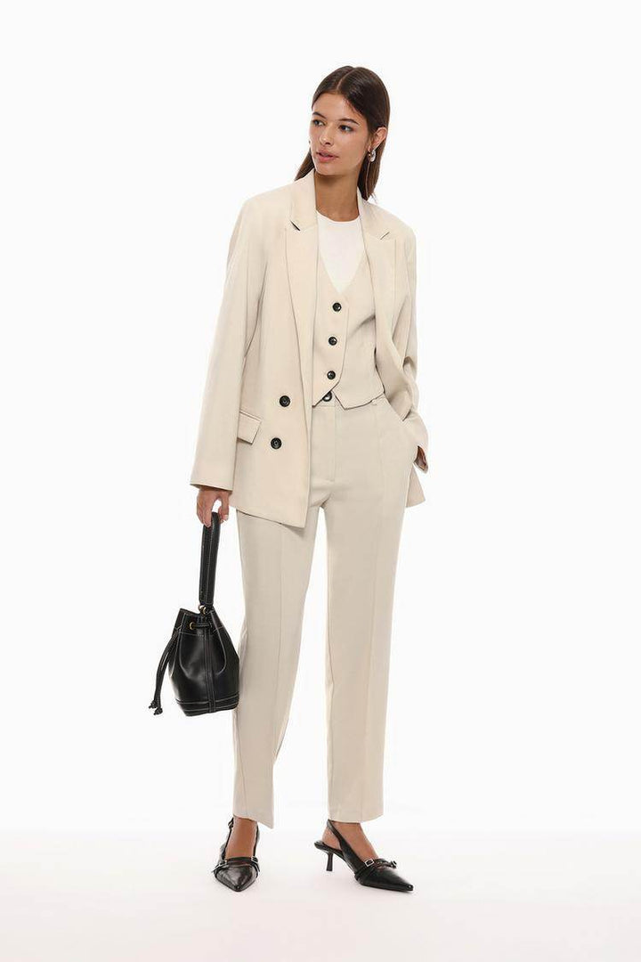 Full body front view of woman wearing beige basic blazer

