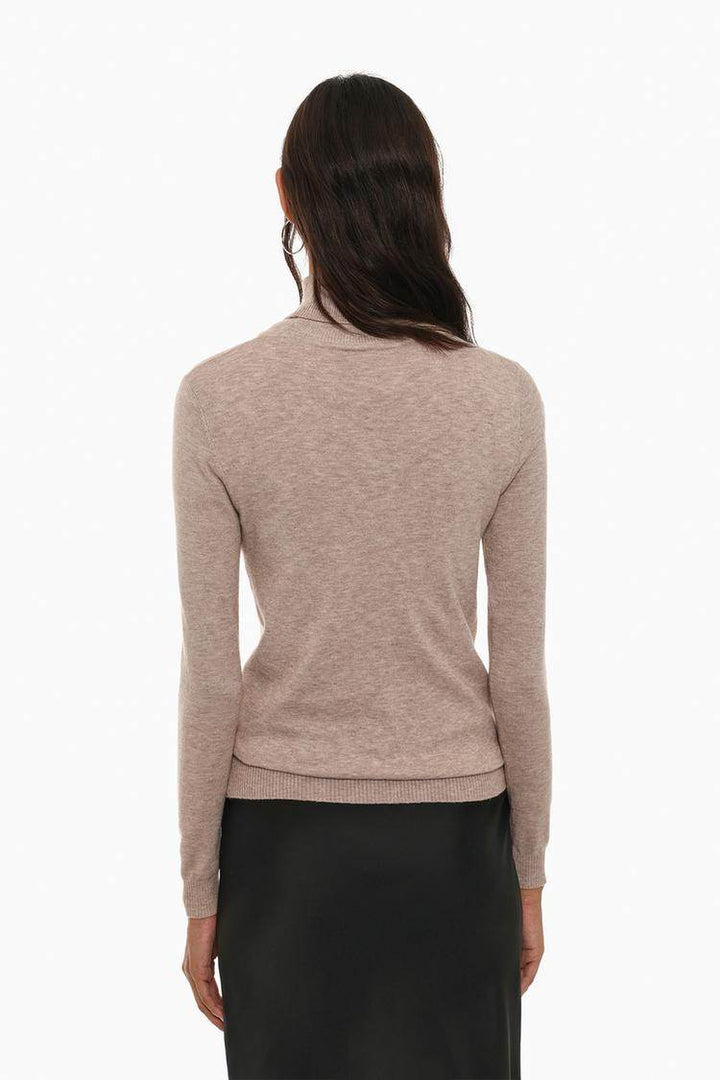 Back view of the women's beige basic turtleneck sweater

