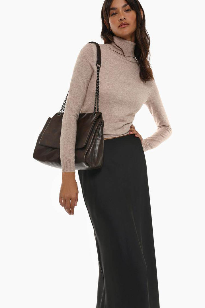 Side view of the women's beige basic turtleneck sweater

