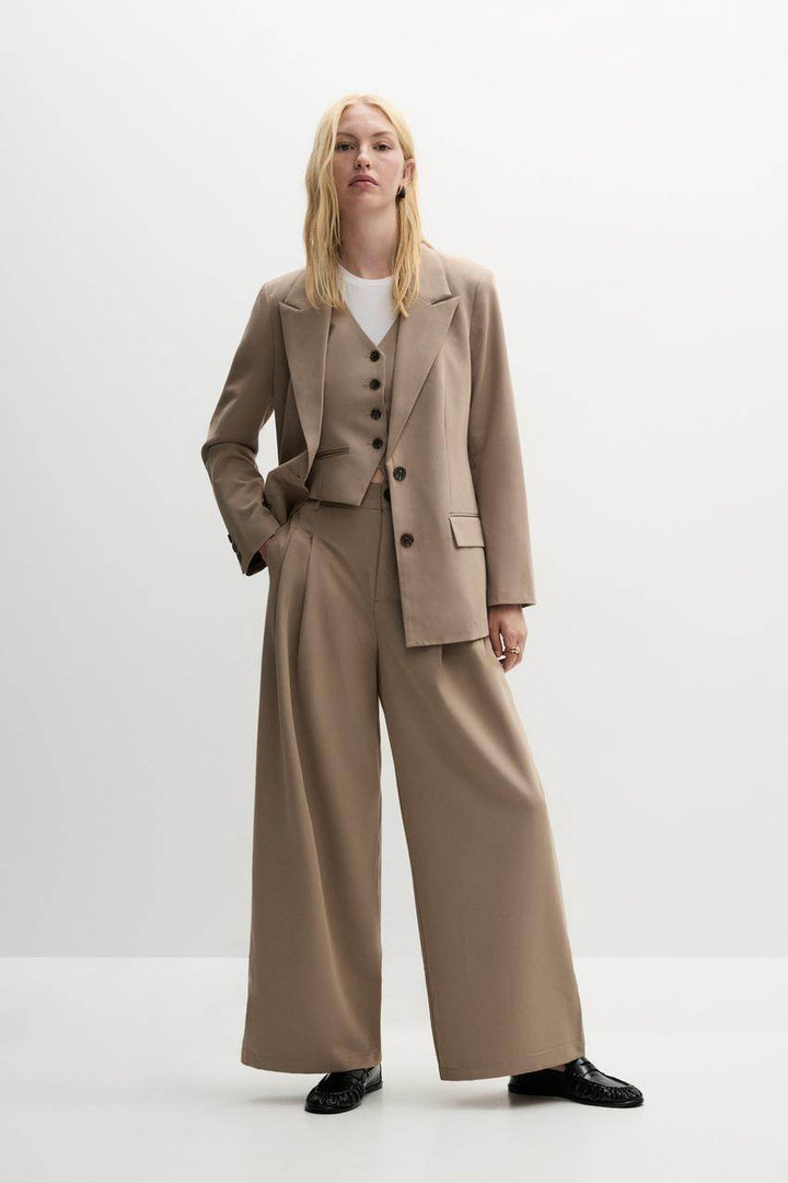 Front full body view of a beige women's blazer
