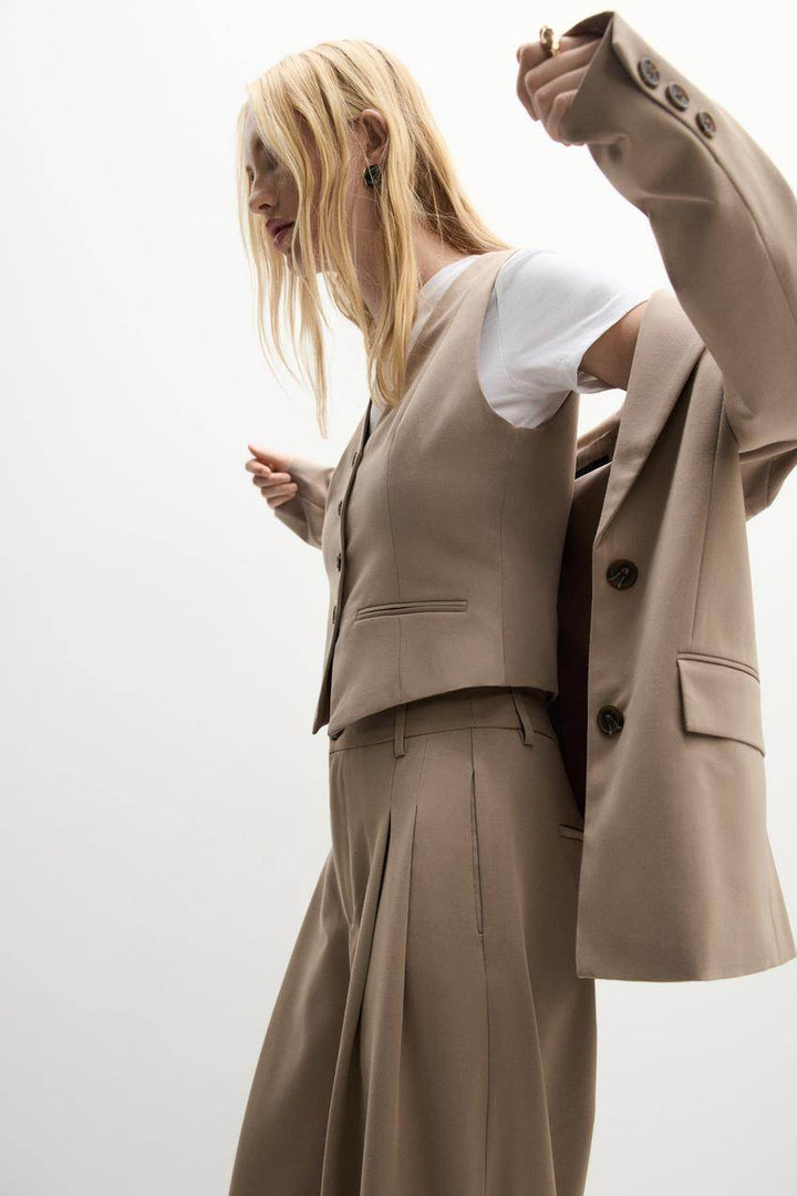 Side view of a beige women's blazer
