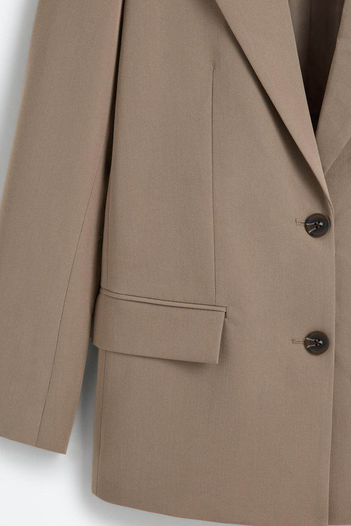 Zoomed view of a beige women's blazer
